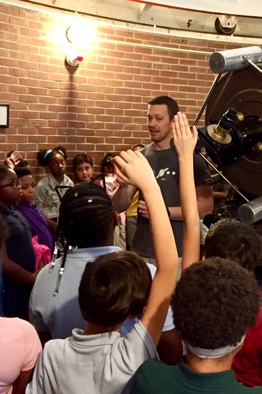 Dr. Billy showing planetarium dome to students