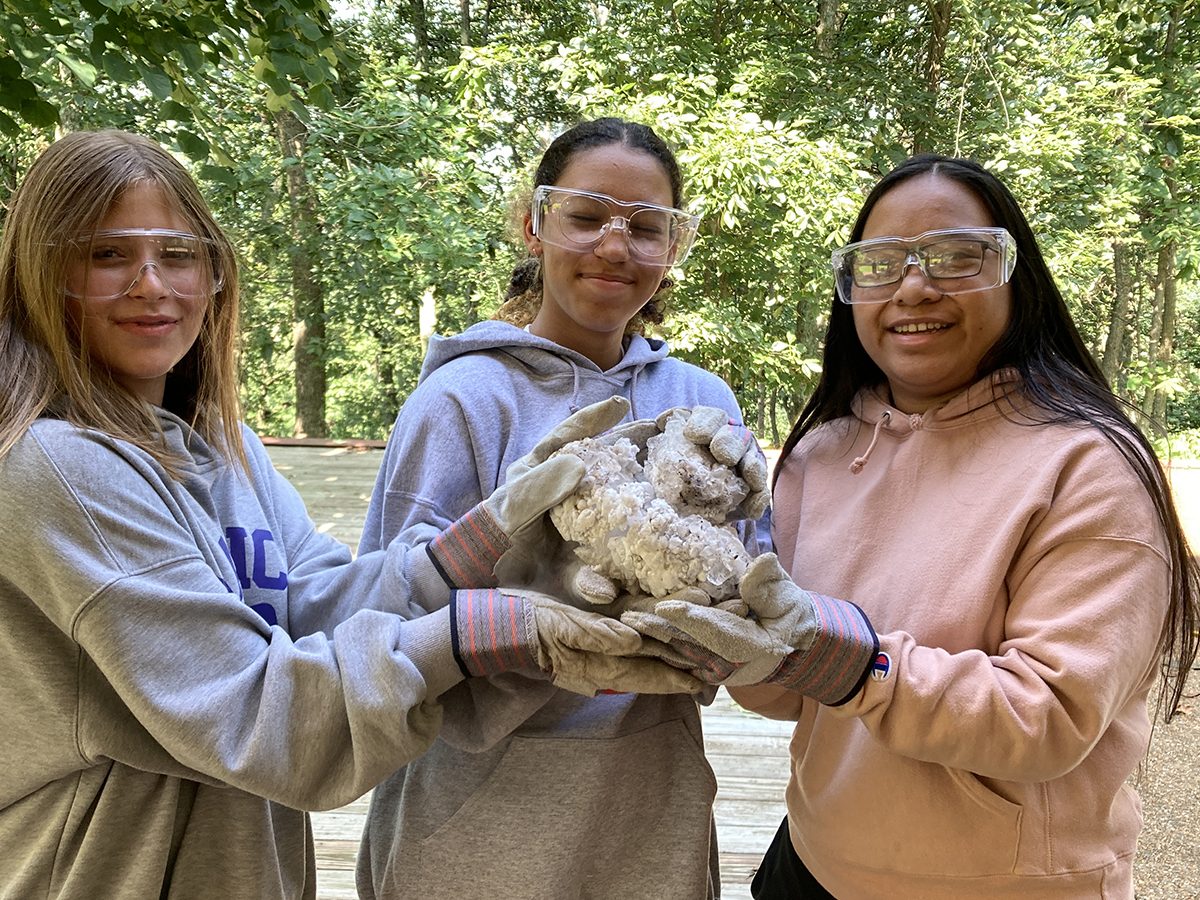 students holding a meteorite